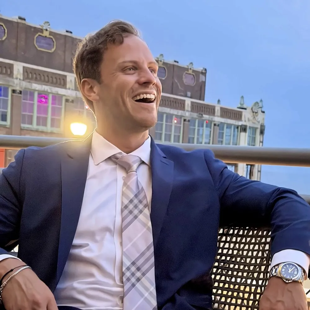 Frankie Paleno, founder of the Katherine Paleno Foundation, smiling outdoors in a navy suit